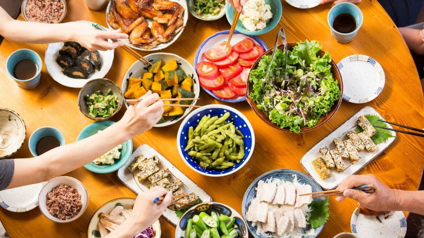 A photo of a scene with various dishes lined up on a dining table